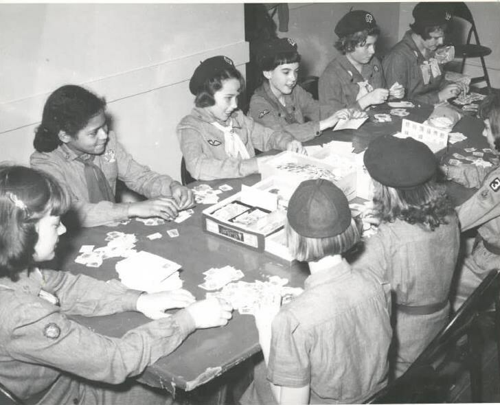 Rainbow Girls and Girl Scouts working on Stamp project.